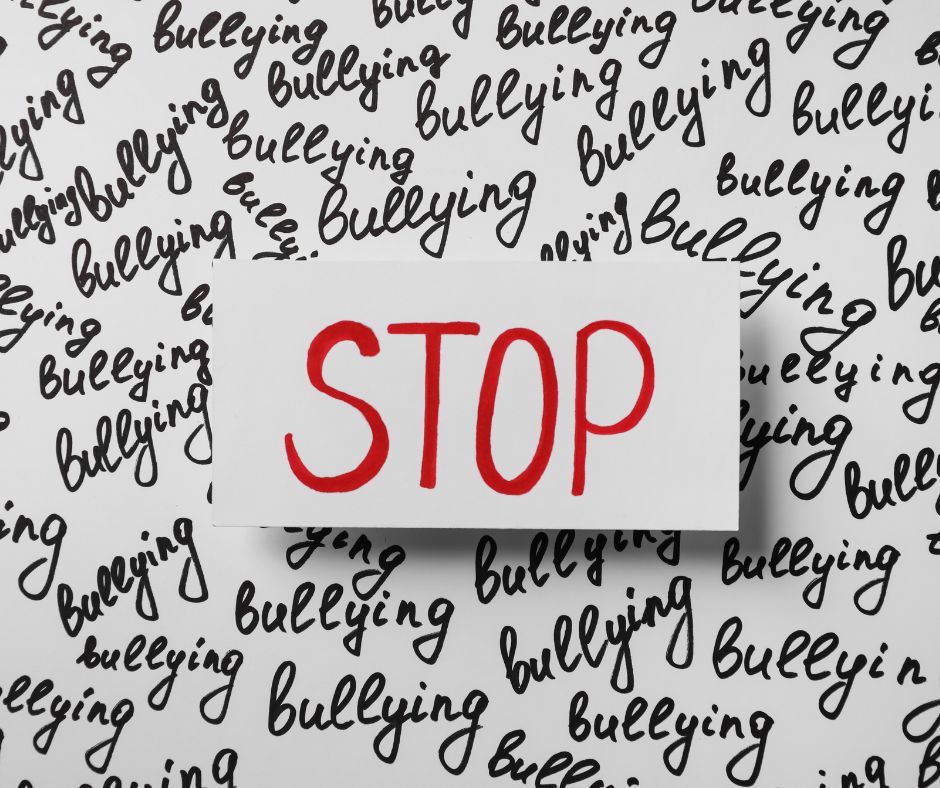 a paper with "stop" written on it in red letters is laying on top of a background with "bullying" written repeatedly